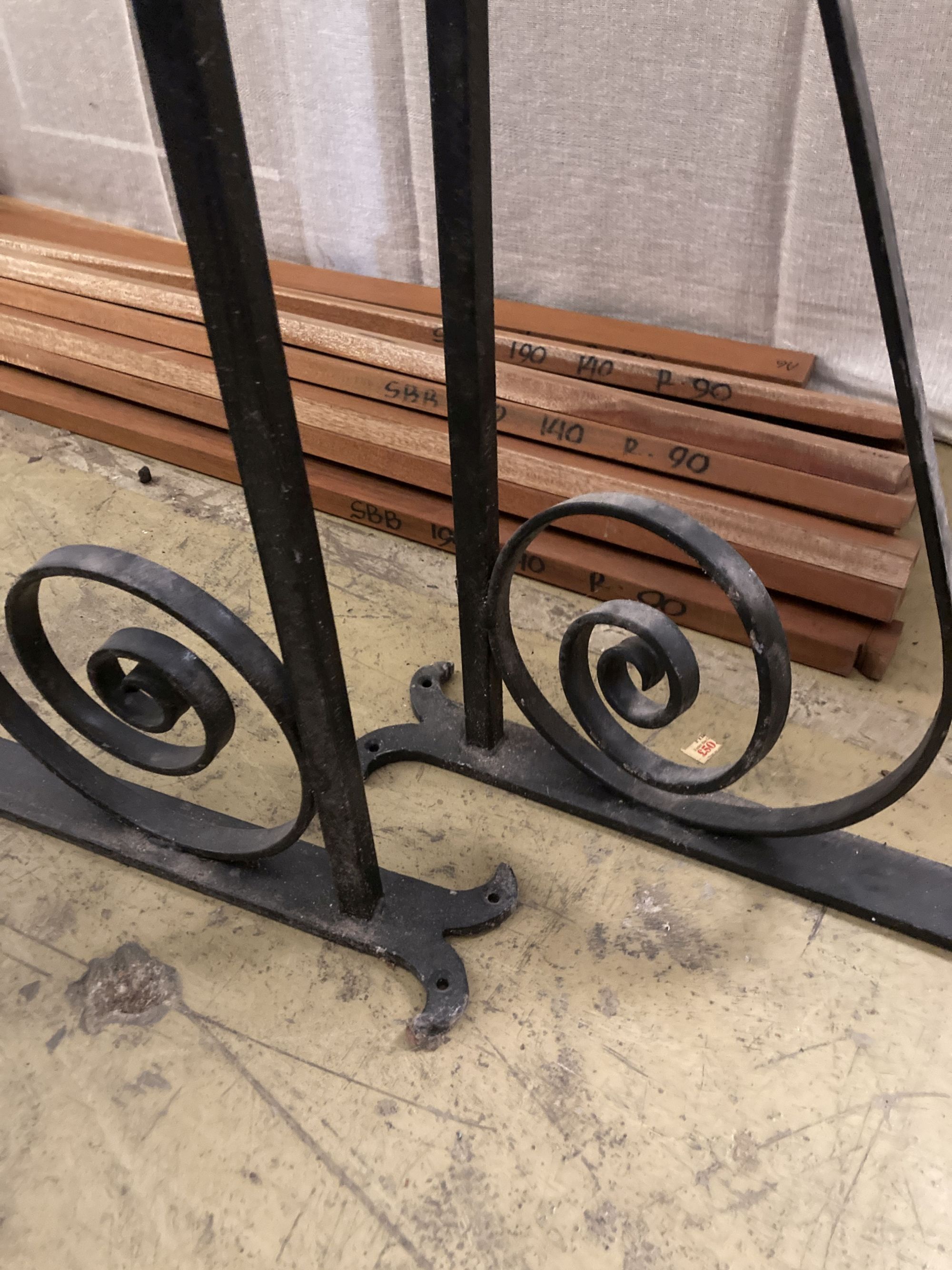 A pair of black painted wrought iron wall mounting brackets, width 114cm, height 54cm